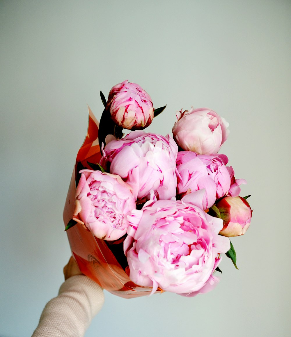 pink roses in brown basket