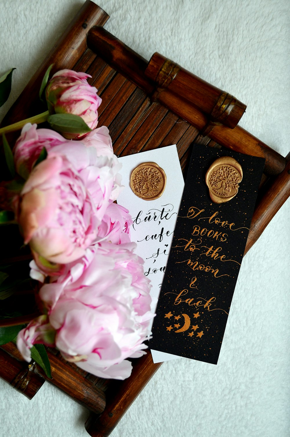 pink roses on brown wooden table