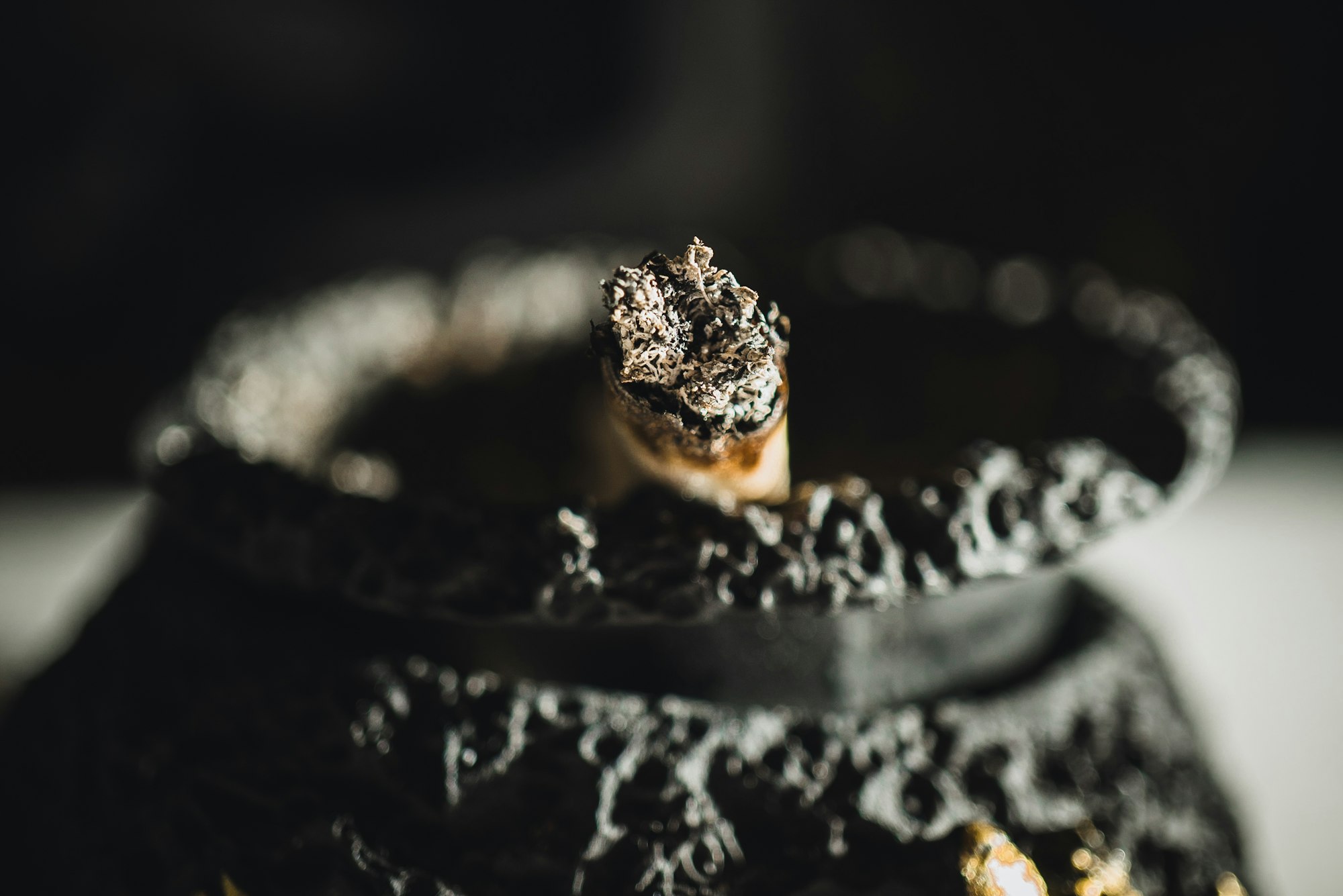 A burnt cigarette / joint in an ashtray.