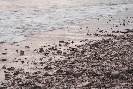 brown and black stones near body of water during daytime in Adelaide SA Australia