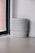 A stack of various sizes of plastic buckets in a bright, clean kitchen setting.