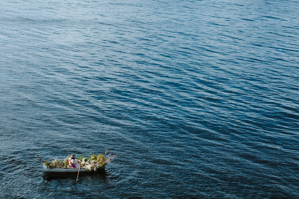 2 people on boat on sea during daytime