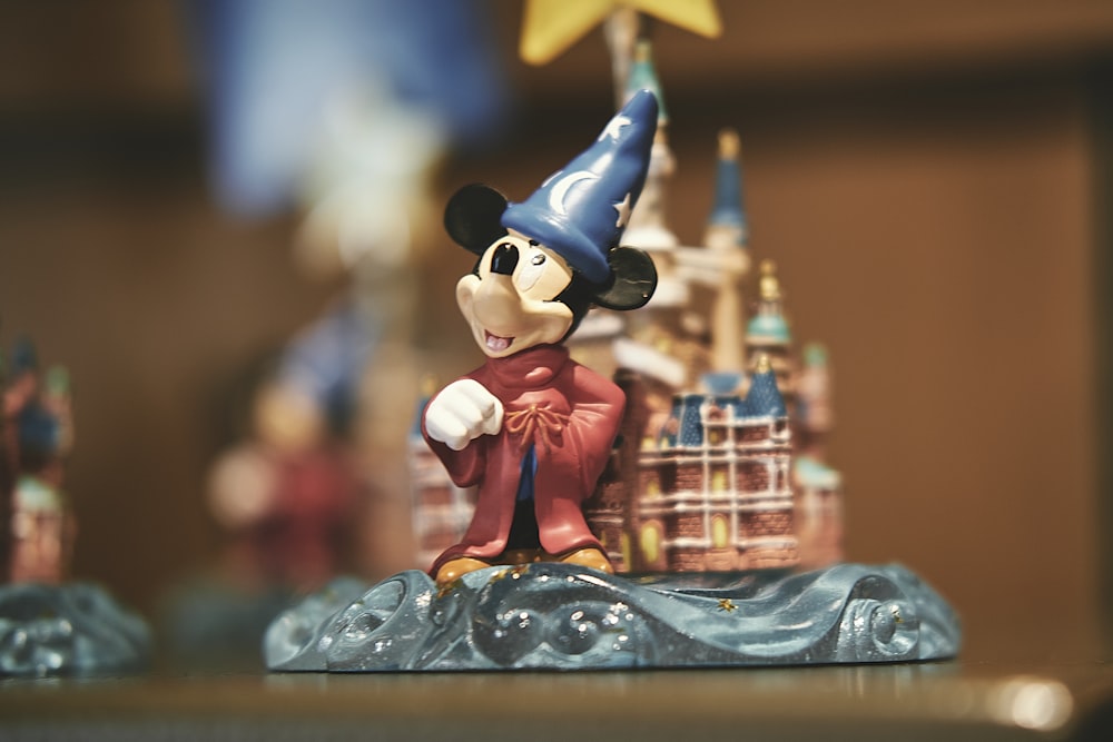 mickey mouse figurine on blue table