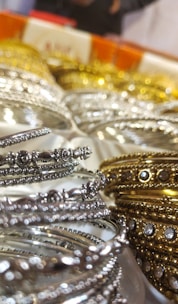 Close-up of intricate brass jewellery pieces with traditional Indian motifs.