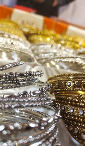 Close-up of intricate Indian wedding accessories like bangles and garlands arranged beautifully.