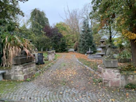 Peaceful garden pathway lined with native plants and calming stone sculptures.