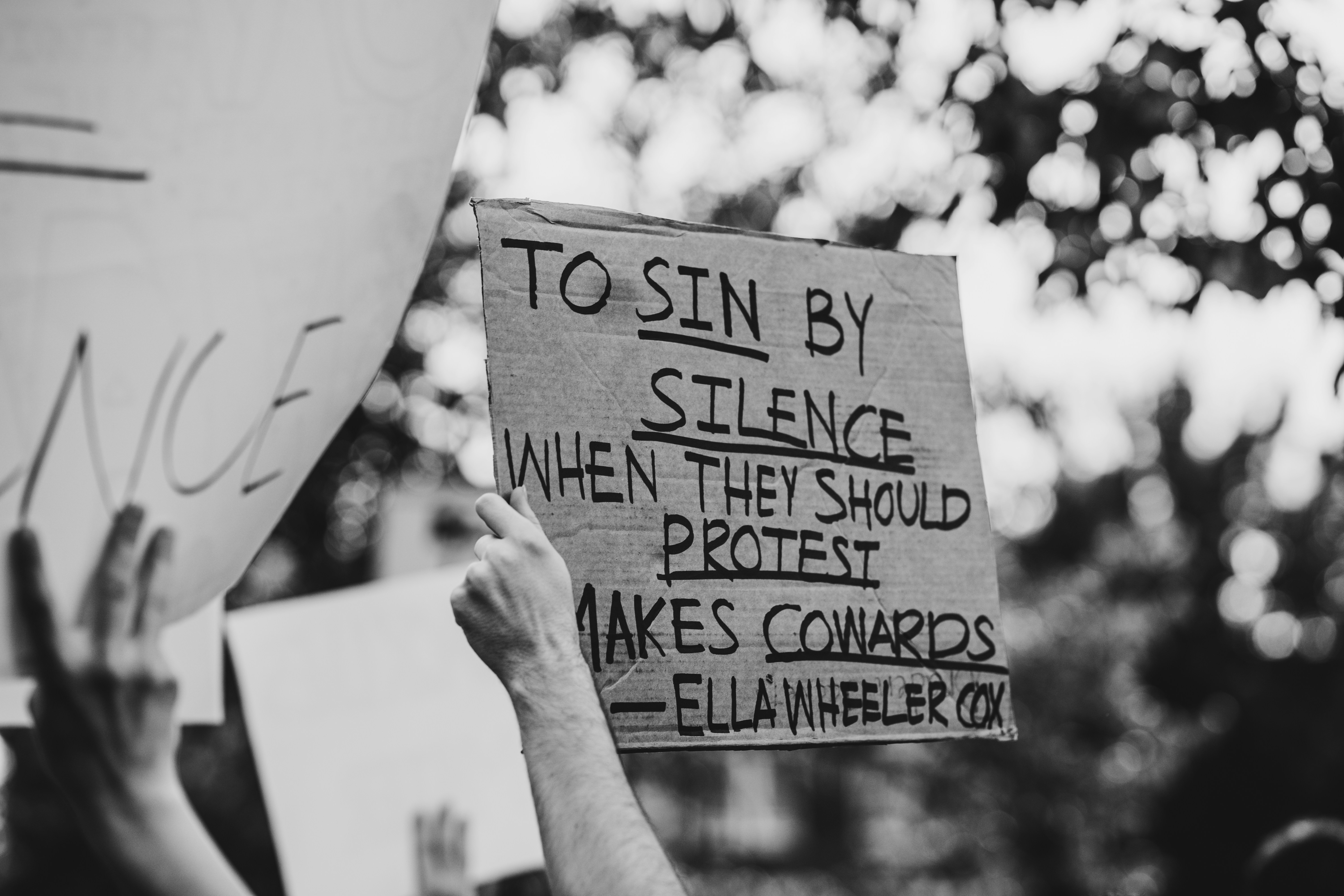 Grayscale photo of person holding happy birthday to you card photo