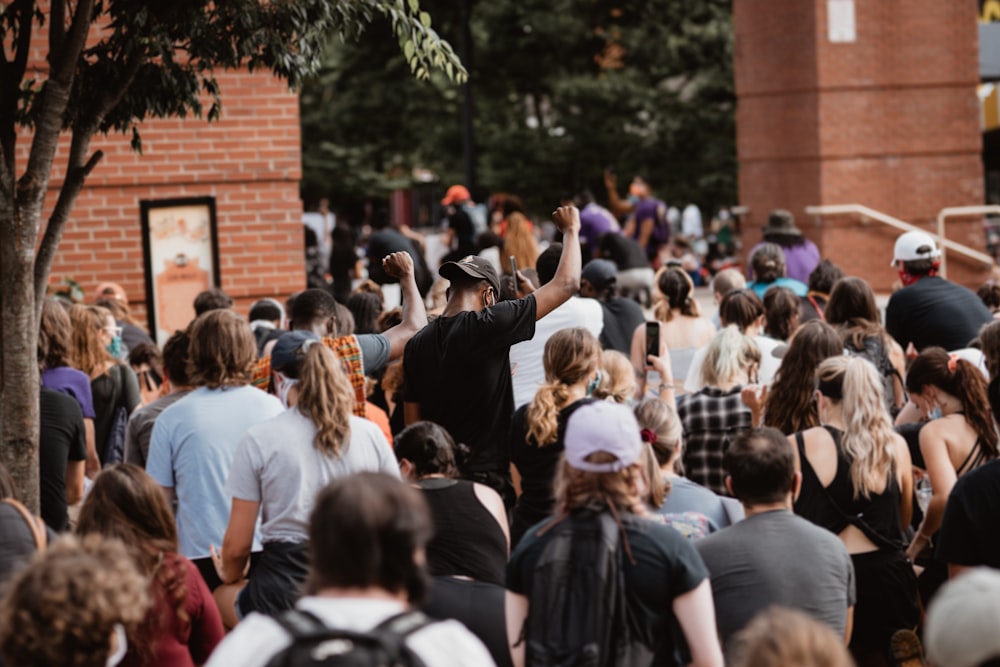 people gathering near brown brick building during daytime