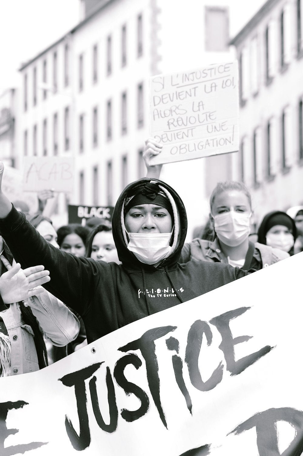 grayscale photo of woman holding signage