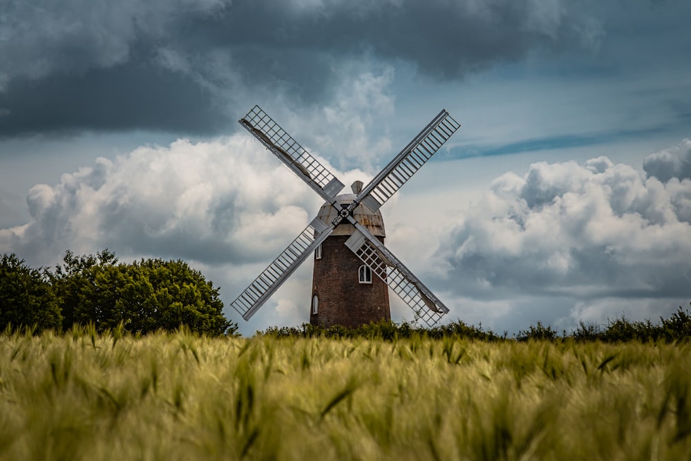 brown and black windmill under cloudy sky during daytime