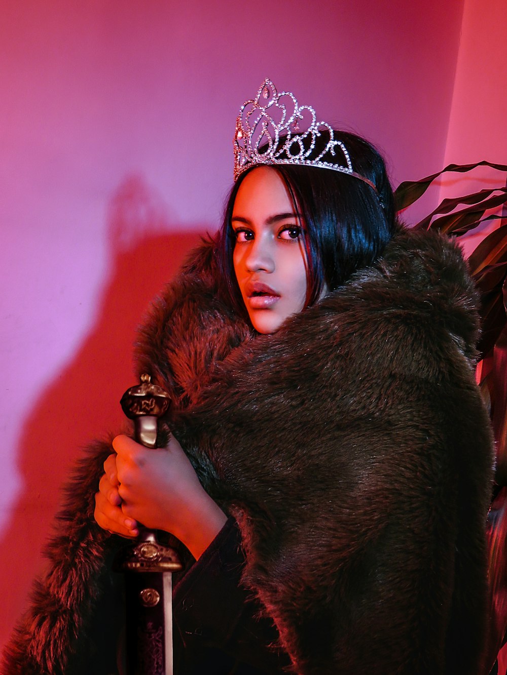 woman in black fur coat wearing silver crown