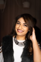 woman in black fur vest