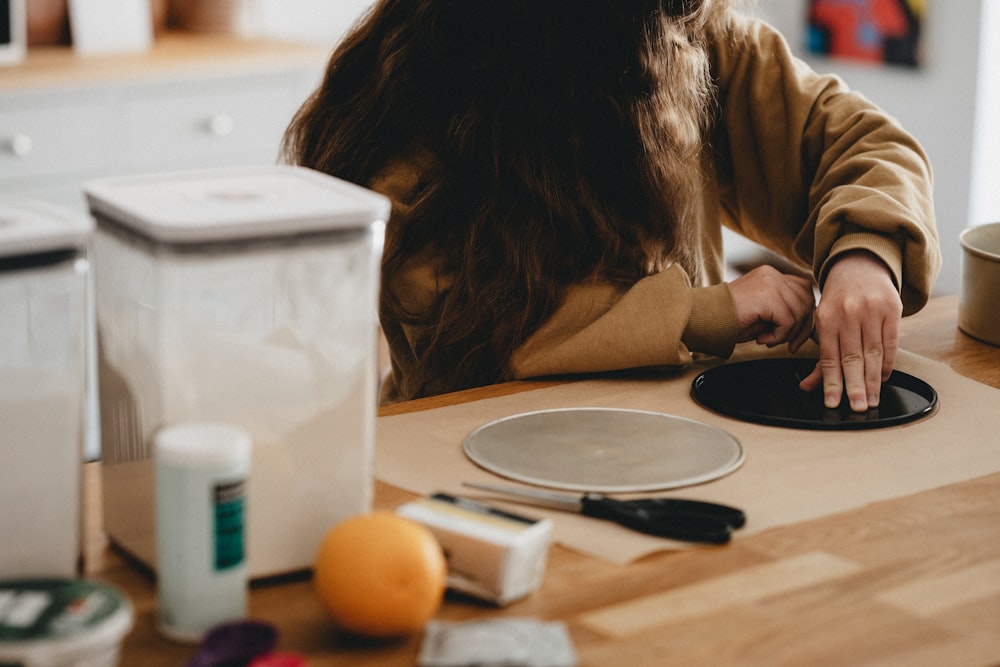 woman in brown long sleeve shirt sitting at the table