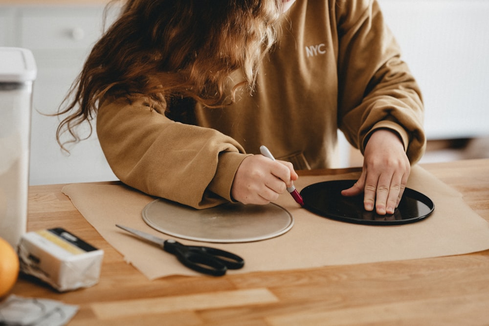 woman in brown long sleeve shirt sitting at the table