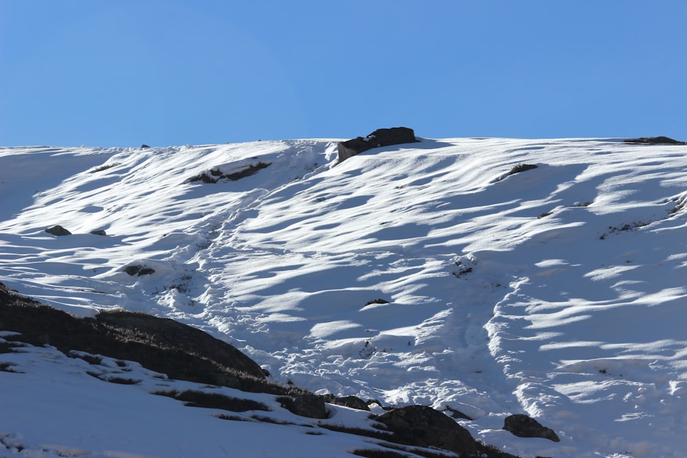 snow covered mountain under blue sky during daytime