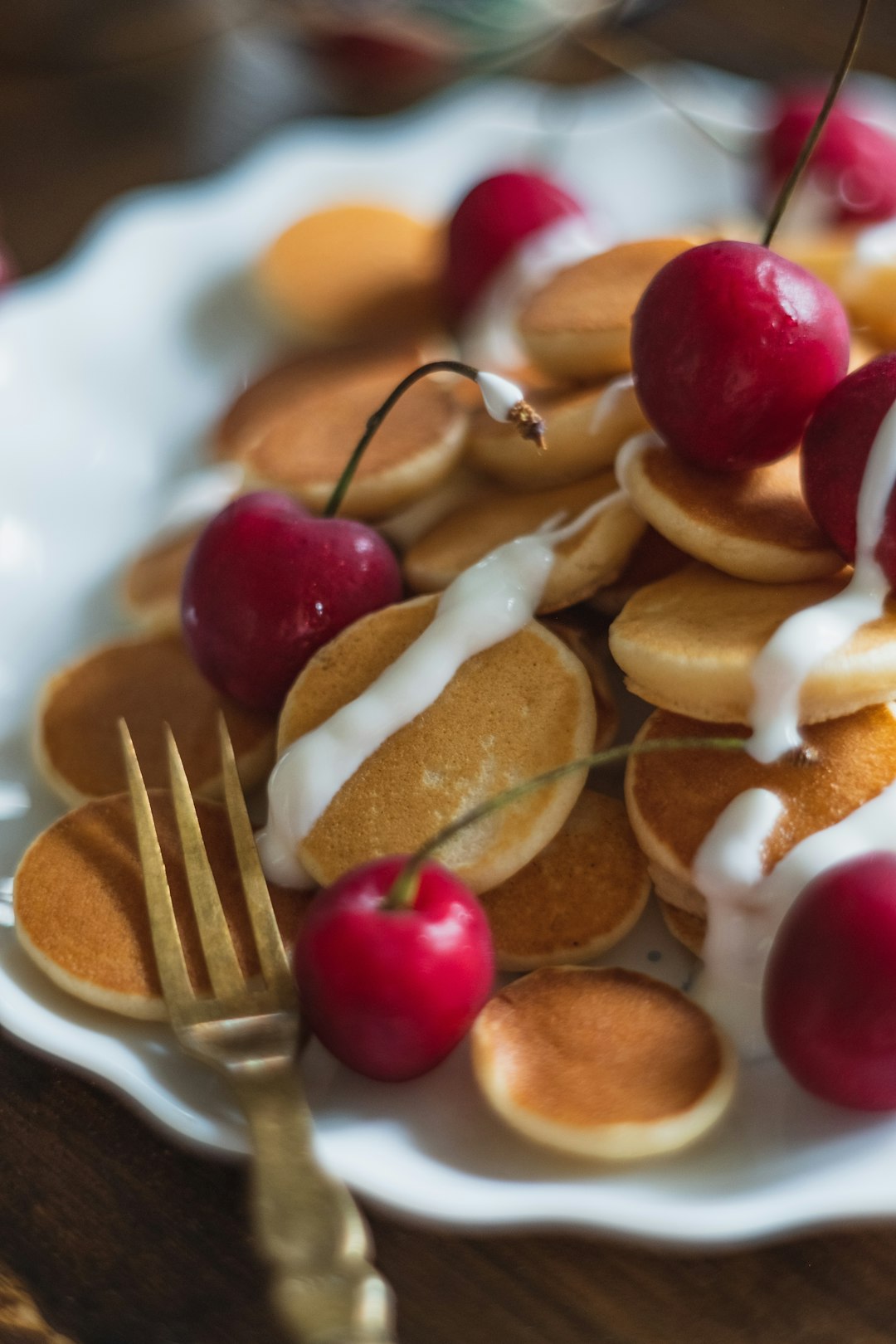 brown and white pastry with red cherry on top