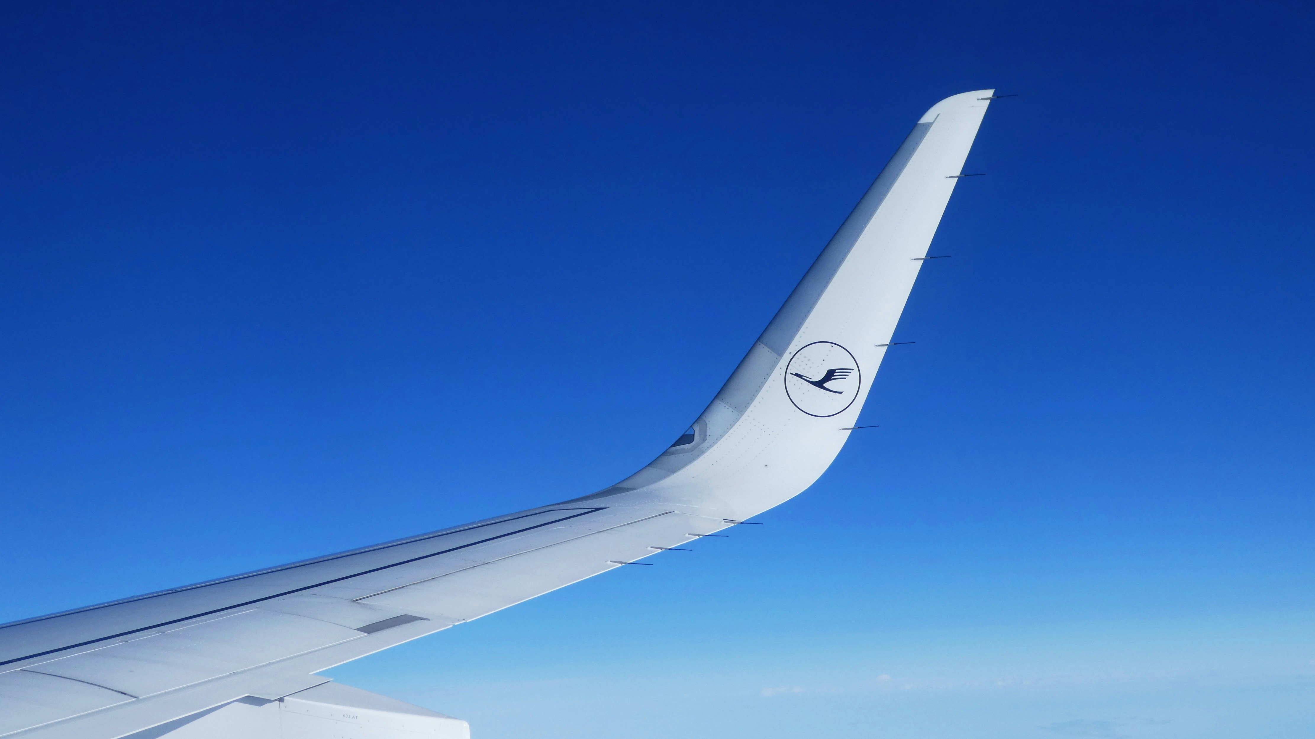 white and gray airplane wing during daytime, A winglet of an Airbus A320 from Lufthansa.