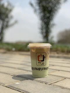 Close-up of a Fiercenest branded insulated tumbler filled with a refreshing drink on a game day picnic table.