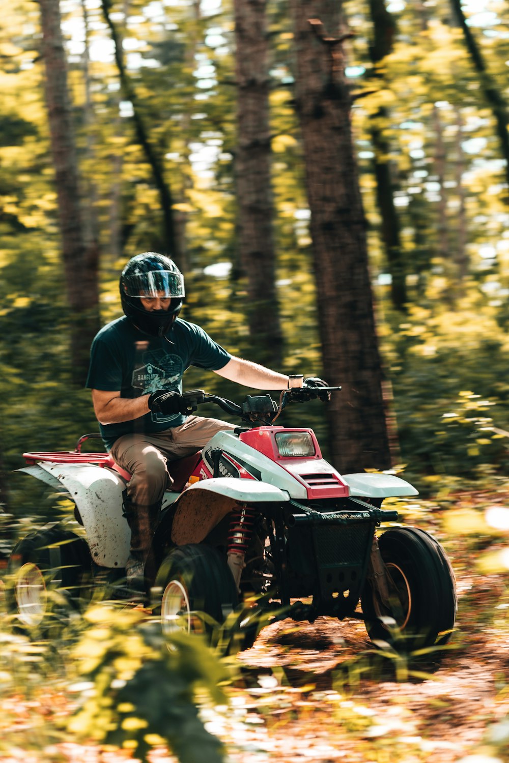 man riding atv in forest during daytime