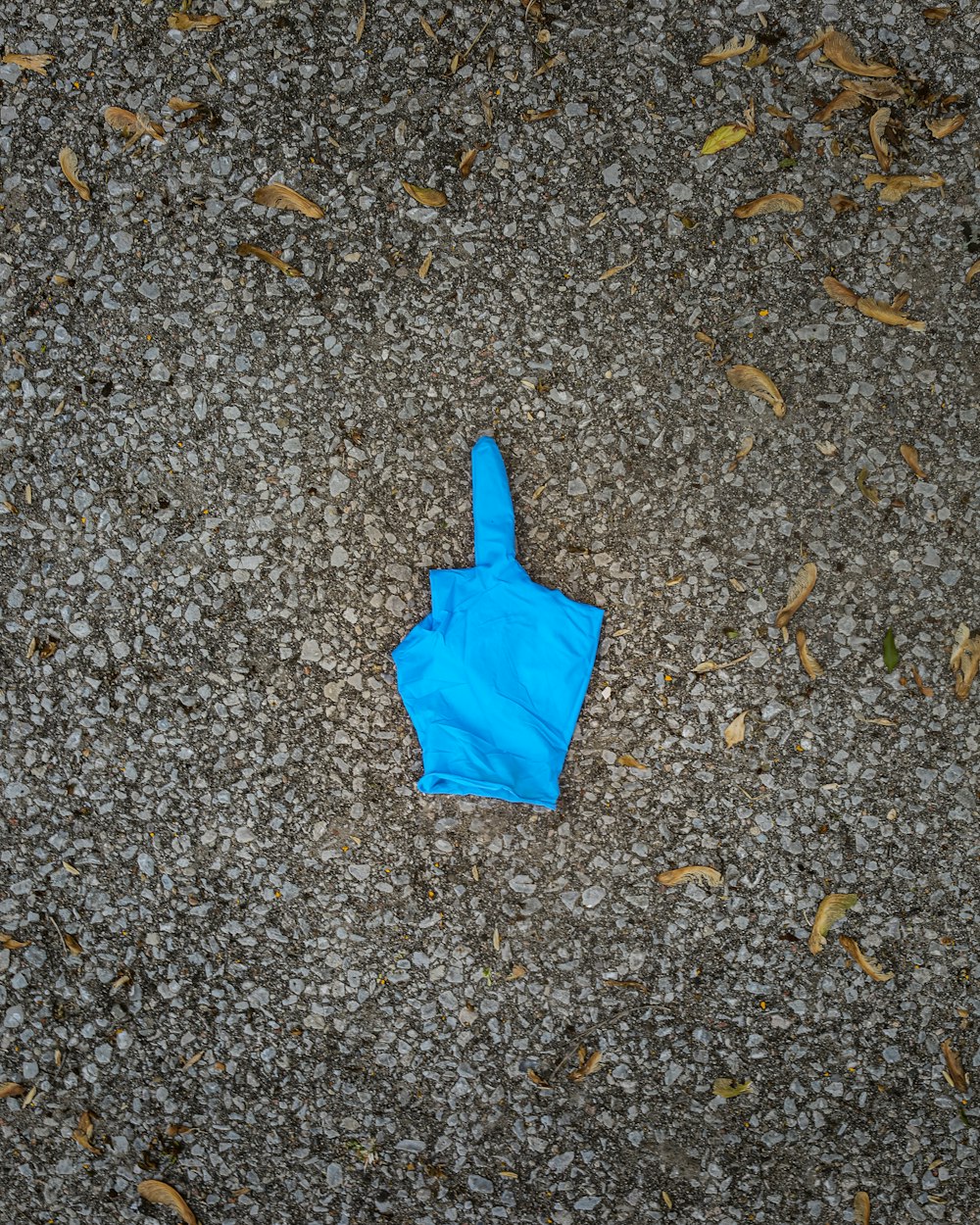 blue balloon on gray ground