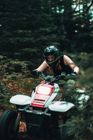 man in black helmet riding on red and white motorcycle