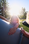 Close-up of a joyful child playing in a sunlit park.