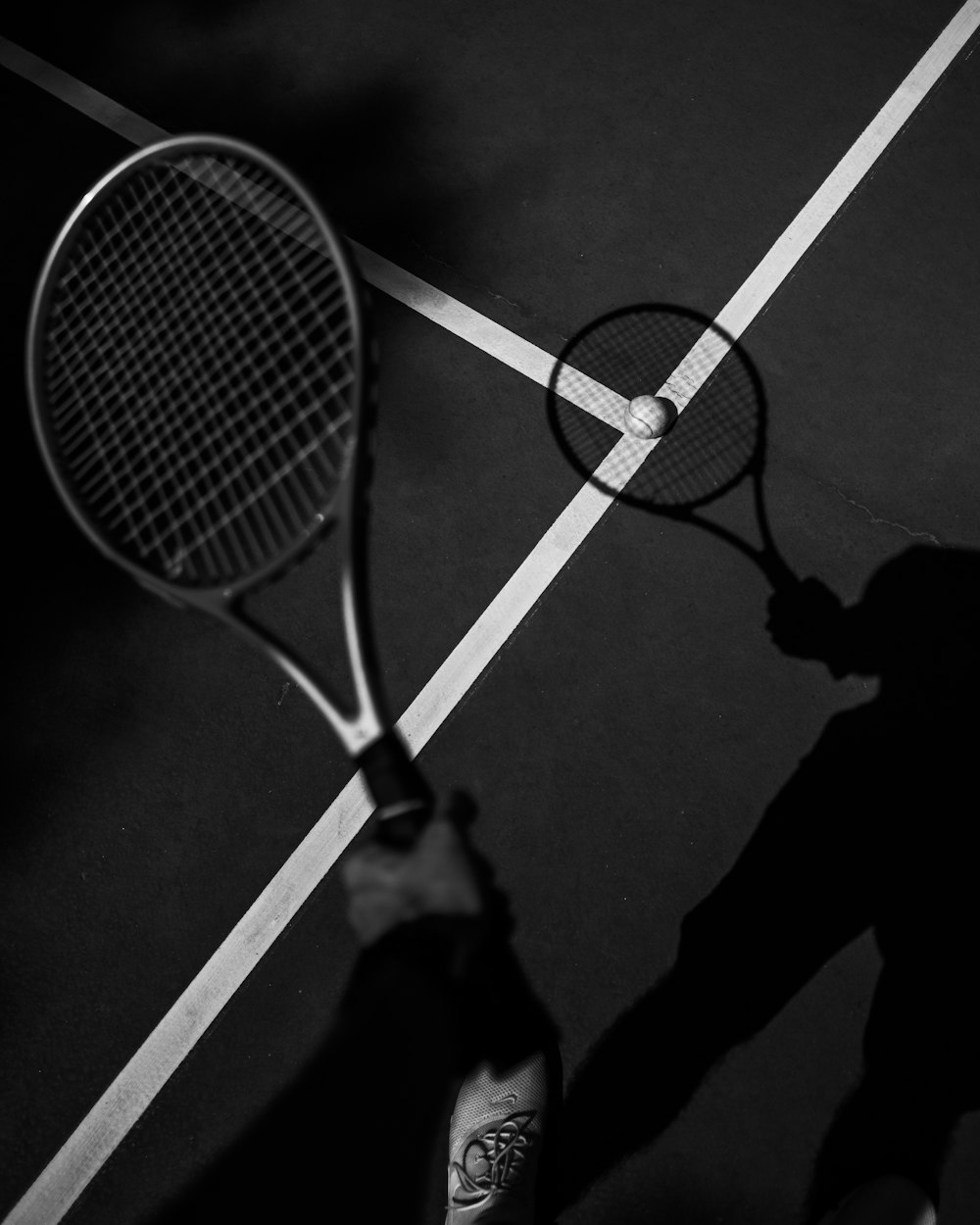 person holding blue and white tennis racket