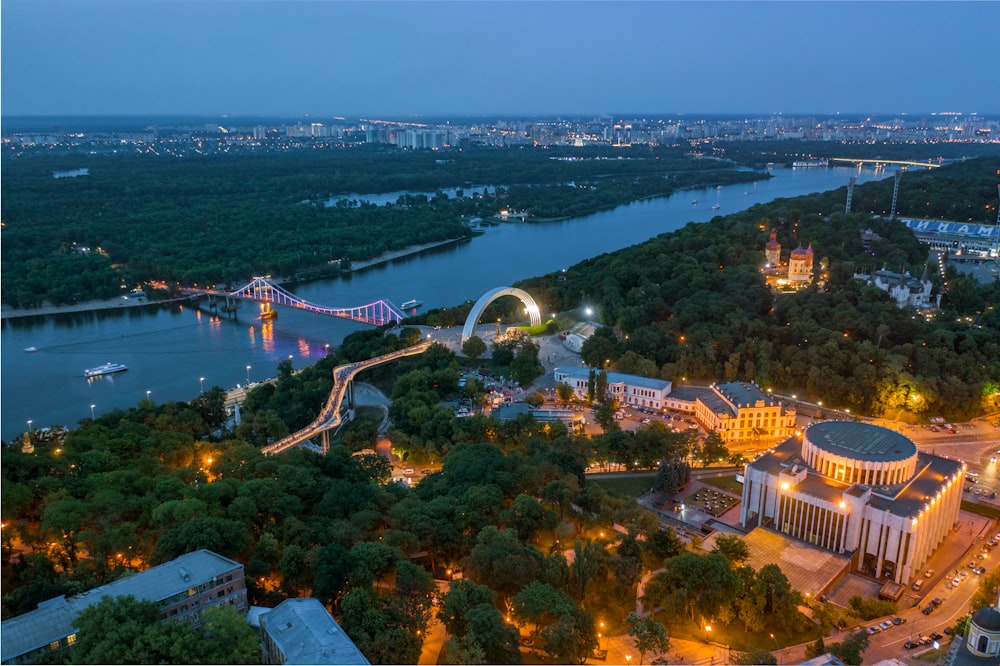 aerial view of city buildings near body of water during night time