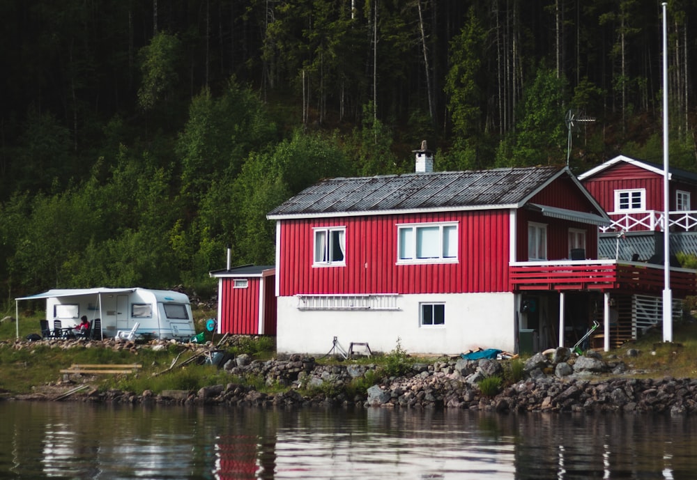 red and white house beside river during daytime