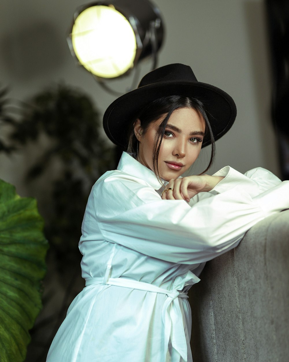 woman in white long sleeve shirt and black hat