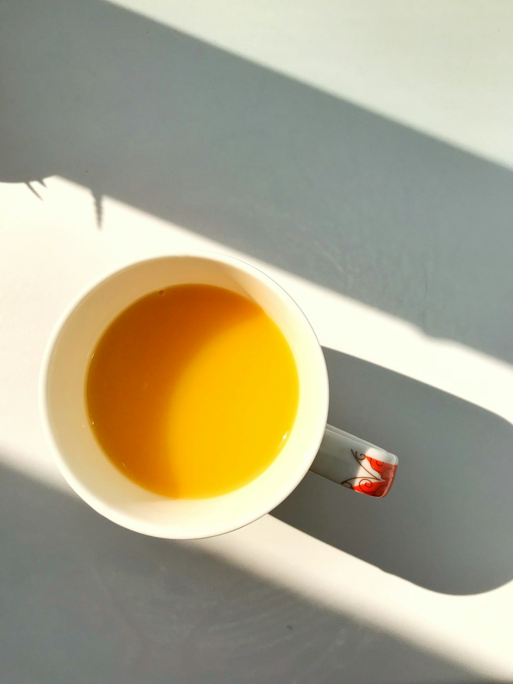 white ceramic mug with brown liquid