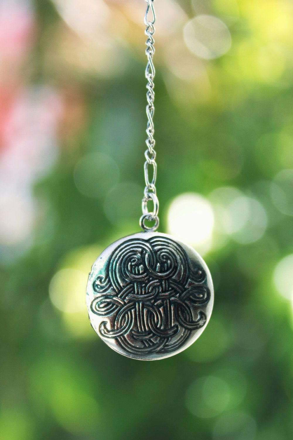 silver round pendant necklace in tilt shift lens