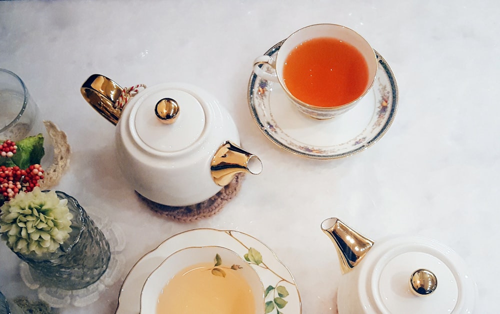 white ceramic teacup with saucer on table