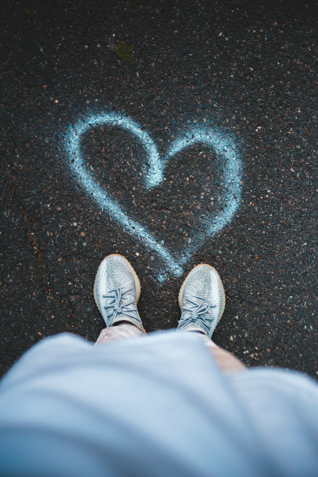 person in white pants and white sneakers