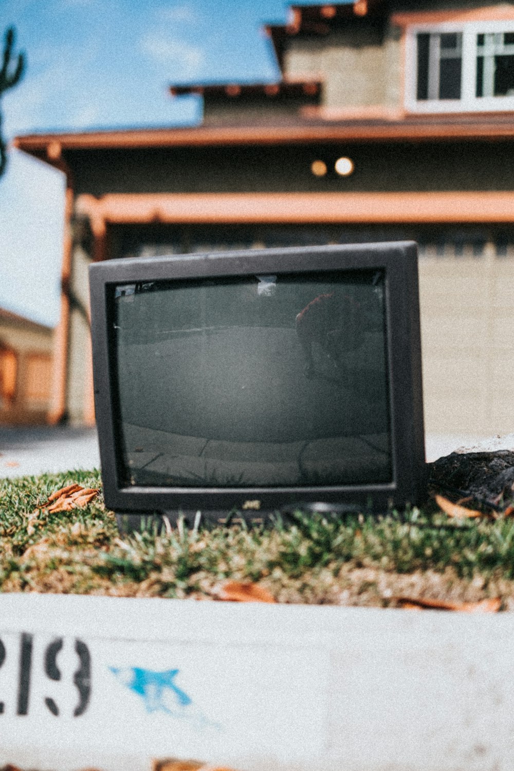 black crt tv on green grass during daytime