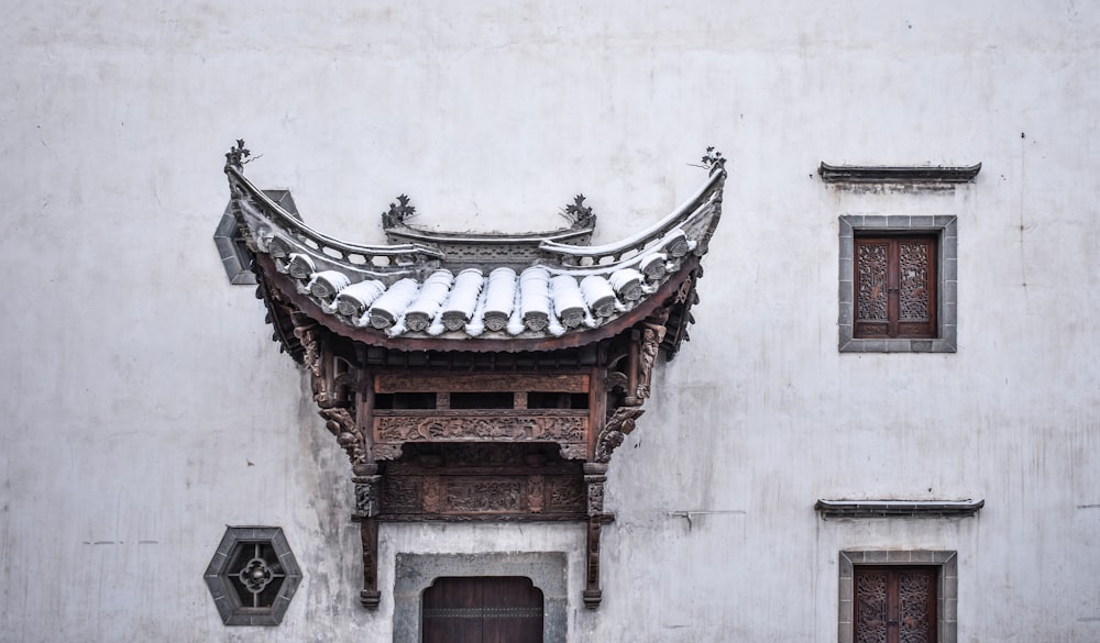 brown wooden roof with white wall