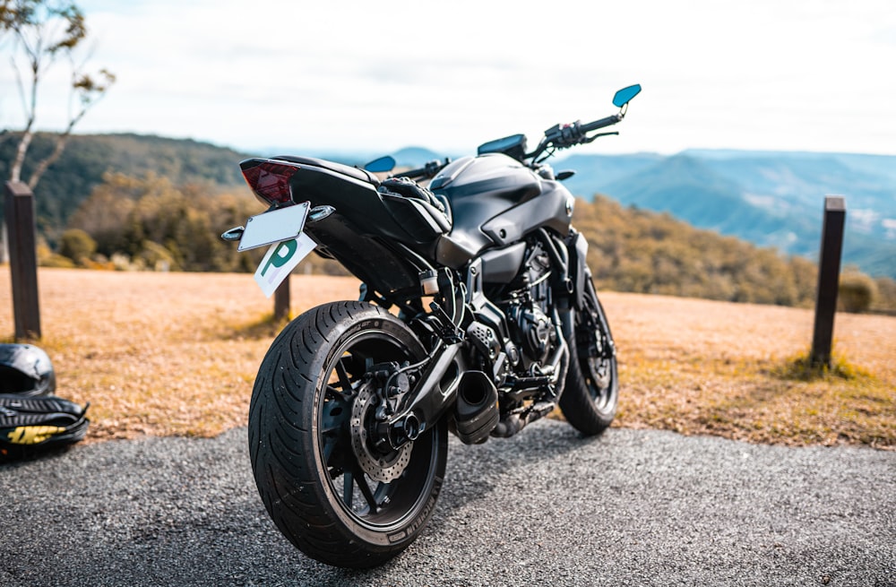 black and gray sports bike on gray asphalt road during daytime