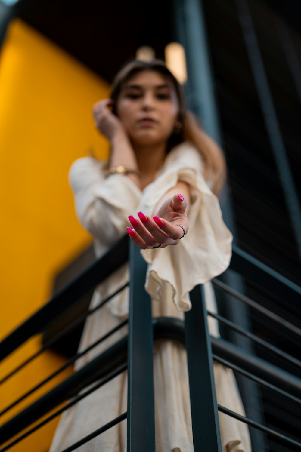 woman in white long sleeve shirt holding pink rose