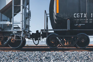 black and yellow train on rail tracks