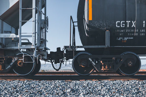 black and yellow train on rail tracks