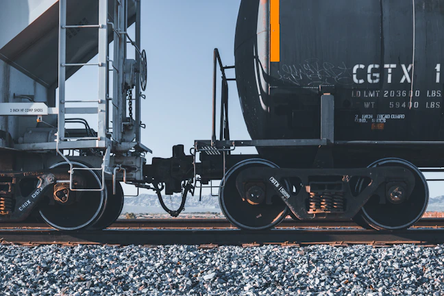 black and yellow train on rail tracks