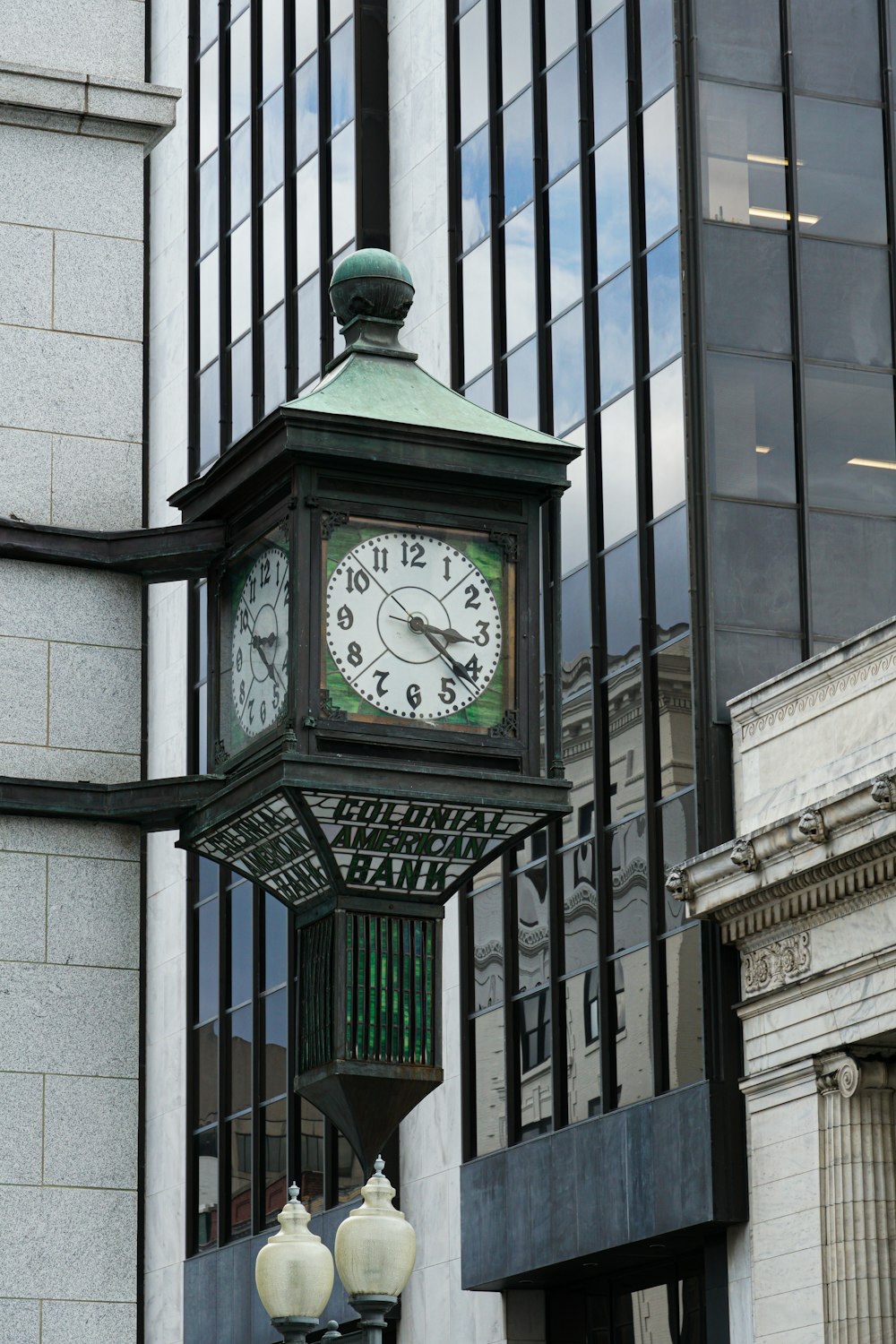 green and white analog clock at 11 00