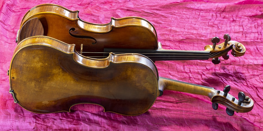 brown violin on red textile