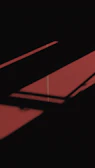 Elegant interplay of light and shadow on textured gold and red surfaces.