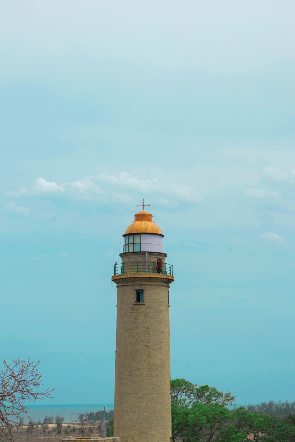 white and brown lighthouse under blue sky during daytime