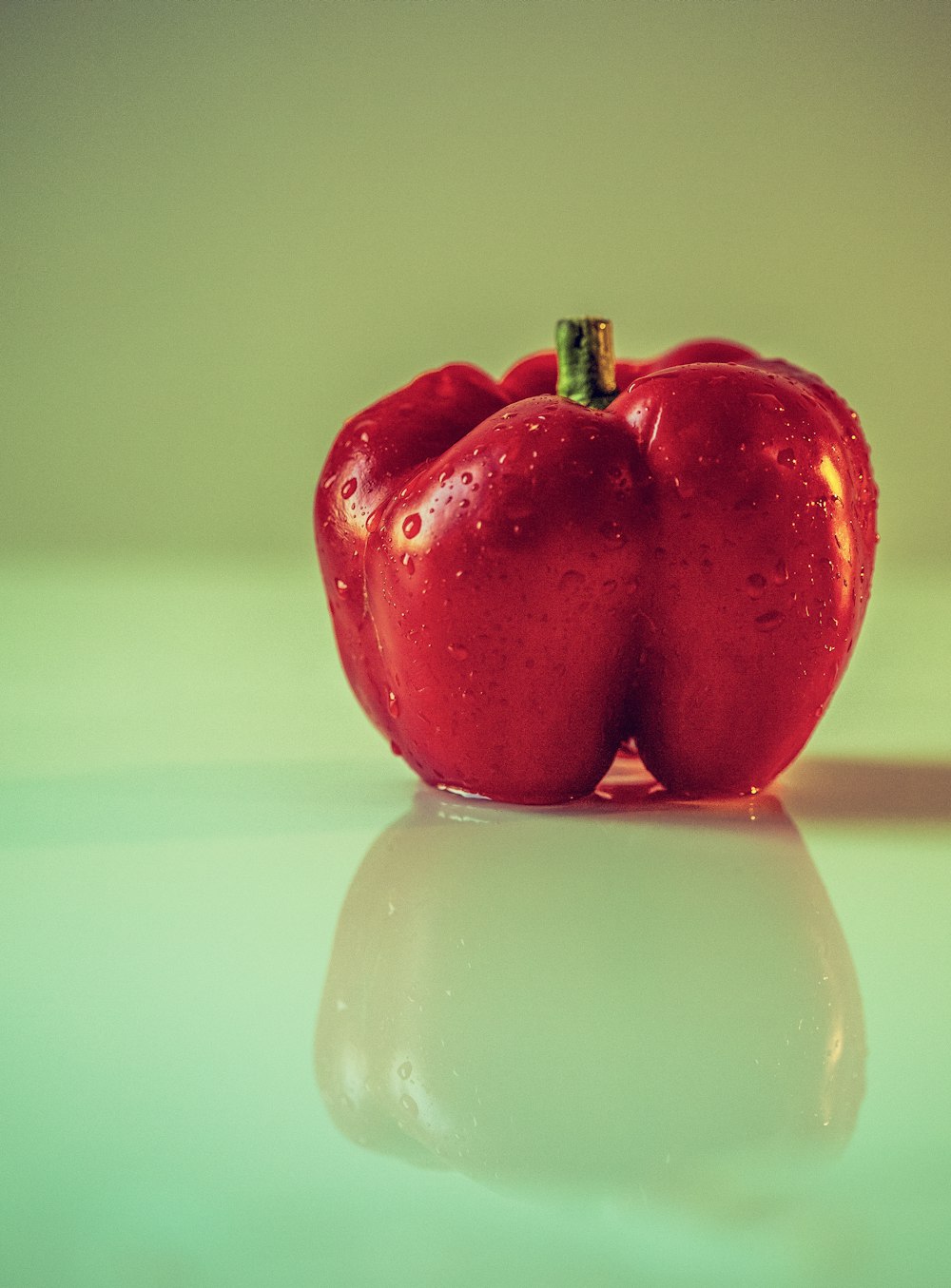 a couple of red peppers sitting on top of a table