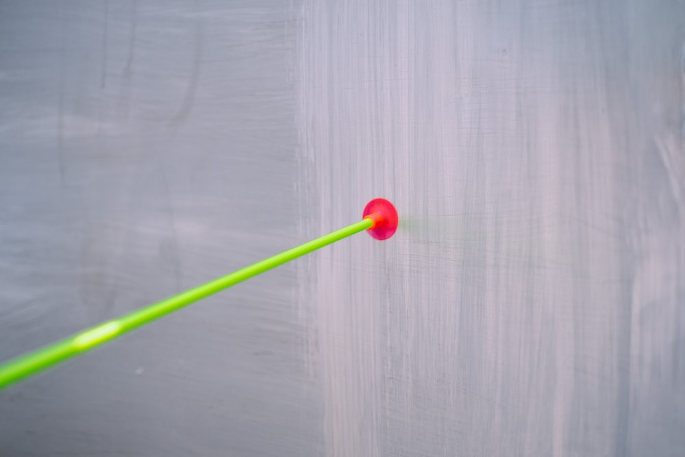 green and red lollipop on white wooden table