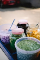 An assortment of colorful protein powders in jars.