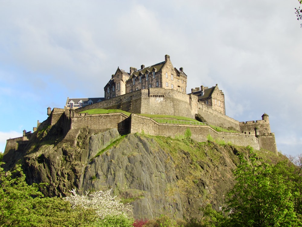 gray concrete castle on top of mountain during daytime