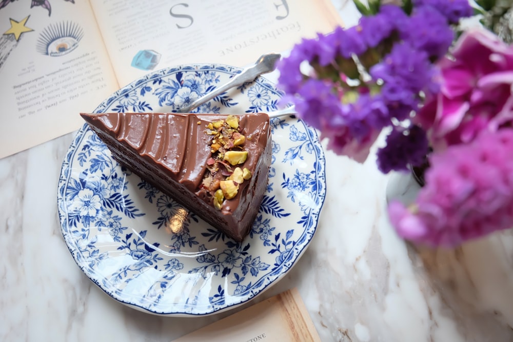 chocolate cake on white and blue floral ceramic plate